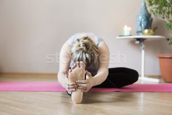 Middle aged woman doing yoga indoors Stock photo © dashapetrenko