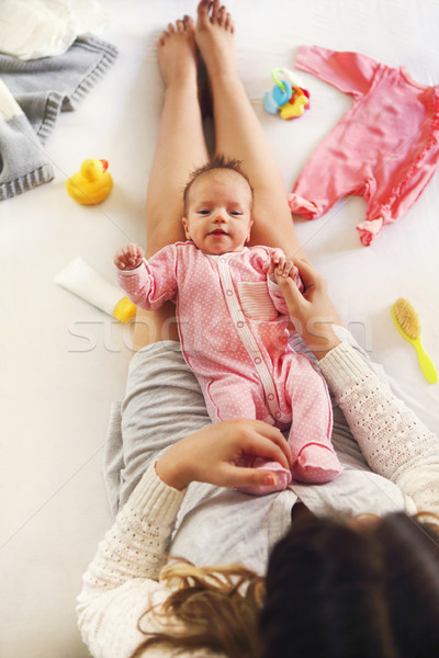 Stock photo: Young mother holding her newborn child