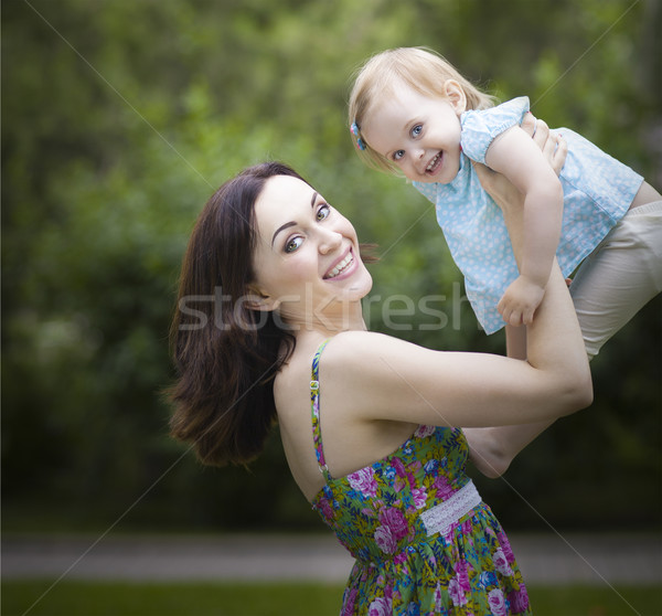 Beautiful young mother with daughter in summer park Stock photo © dashapetrenko