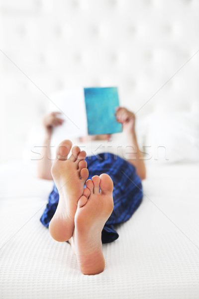 Young man reading book in the bed Stock photo © dashapetrenko