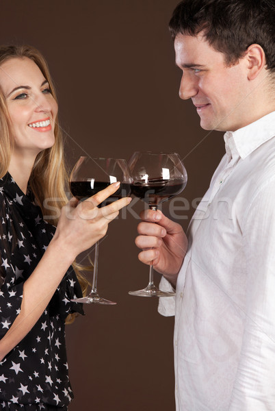 Young happy couple enjoying a glasses of wine Stock photo © dashapetrenko