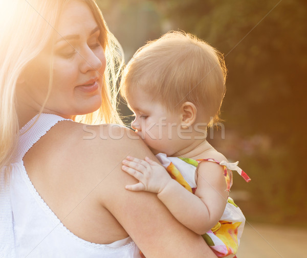 Stock photo: Happy mother and her baby 