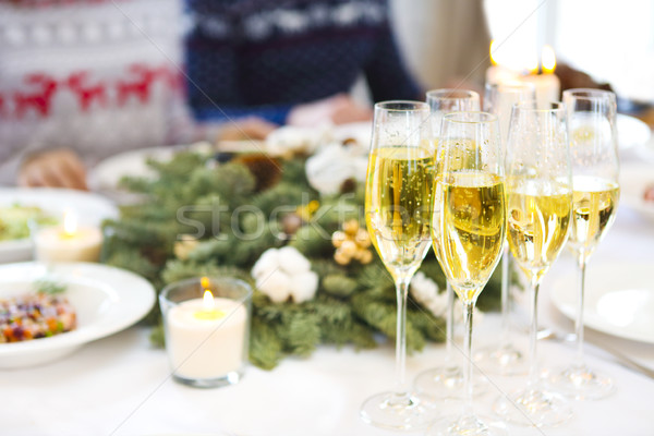 Champagne into a glasses standing on the Christmas table Stock photo © dashapetrenko