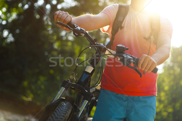 Young man with bicycle by mountain river Stock photo © dashapetrenko