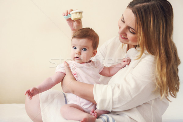 Young woman in the room with baby Stock photo © dashapetrenko