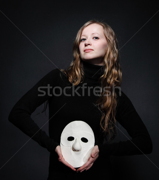Low key portrait of a beautiful woman holding mask Stock photo © dashapetrenko