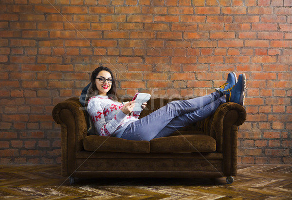 Woman lying on sofa with tablet pc Stock photo © dashapetrenko