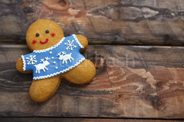 Smiling christmas gingerbread men on wooden background.  Stock photo © dashapetrenko