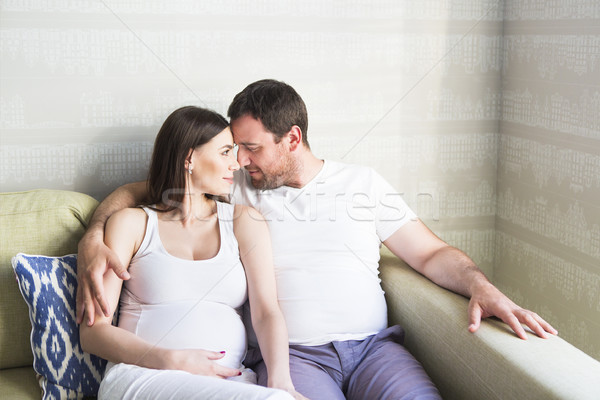Pregnant woman and young man together indoors Stock photo © dashapetrenko
