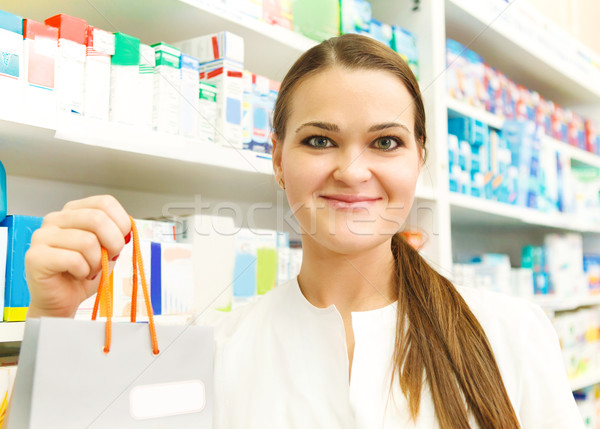 Closeup of a female pharmacist holding packet at drugstore Stock photo © dashapetrenko