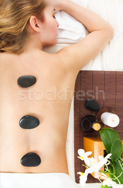 Young woman getting hot stone massage in spa salon Stock photo © dashapetrenko