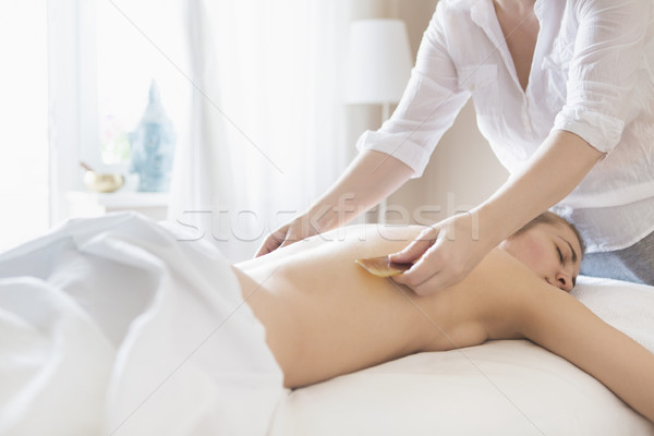 Young woman take back treatment at health spa Stock photo © dashapetrenko