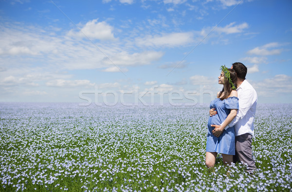Happy beautiful pregnant couple in linen field Stock photo © dashapetrenko