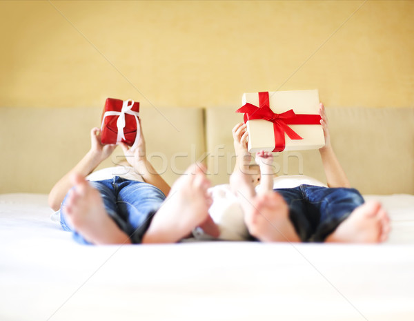 Sweet family in bed. Three sisters, close up on gift box Stock photo © dashapetrenko