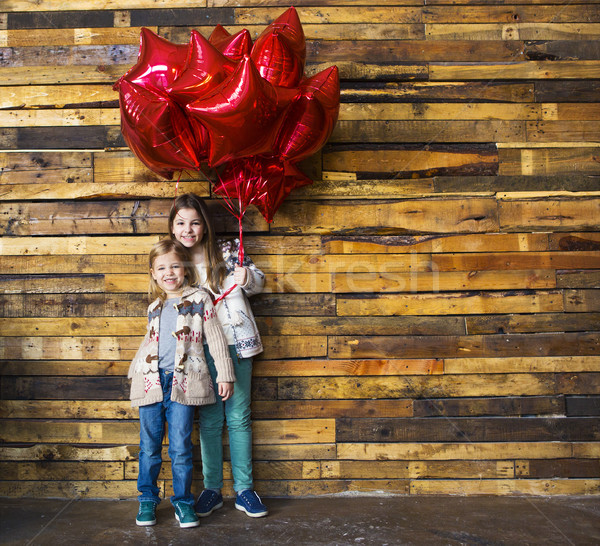 Children with balloons at wooden wall Stock photo © dashapetrenko