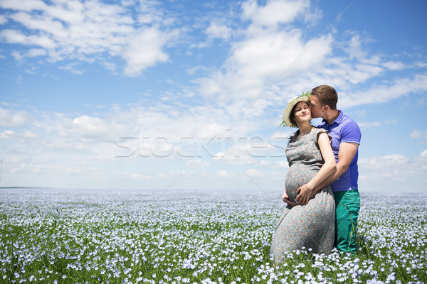 Young happy beautiful pregnant couple in linen field Stock photo © dashapetrenko