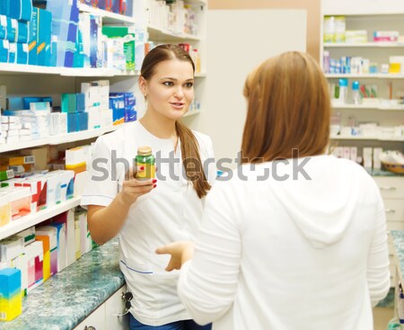Pharmacist suggesting medical drug to buyer  Stock photo © dashapetrenko