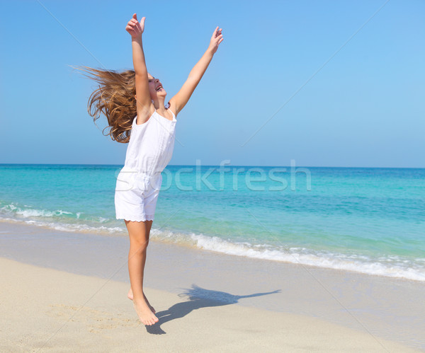 Cute little girl jumping on the beach Stock photo © dashapetrenko