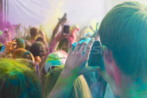 Man taking photo on mobile phone on holi color festival Stock photo © dashapetrenko