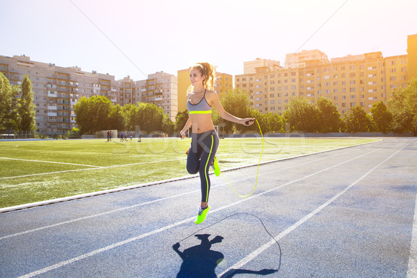 Woman with jumping rope. Beautiful young woman with a jumping ro Stock photo © dashapetrenko