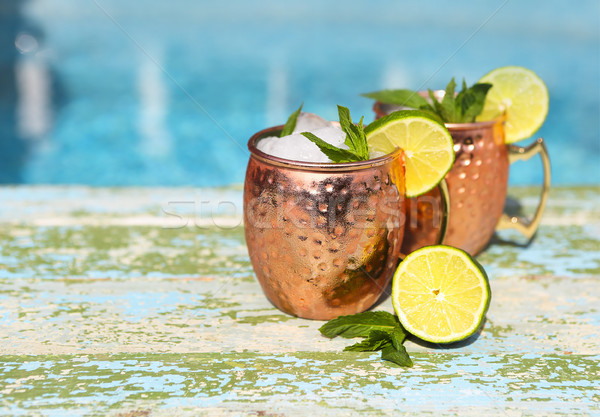 Natural homemade lemonade in cooper mugs on rustic wooden backgr Stock photo © dashapetrenko