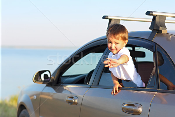 Portrait of a smiling little boy at beach in the car Stock photo © dashapetrenko