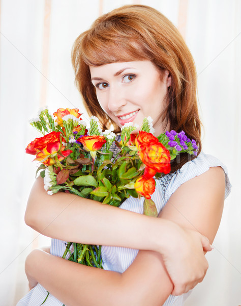 Happy young woman with bouquet of spring flowers Stock photo © dashapetrenko