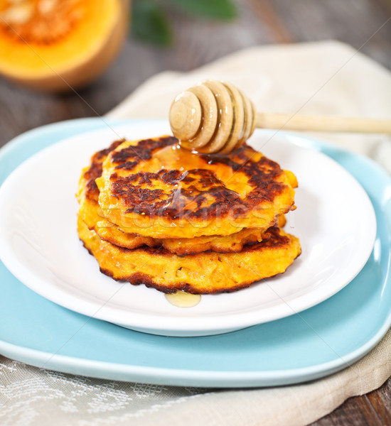 Pumpkin pancakes with honey Stock photo © dashapetrenko