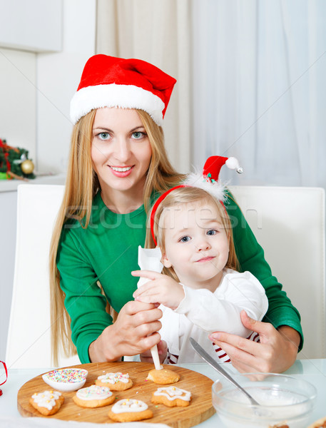 Adorable little girl with her mother baking Christmas cookies  Stock photo © dashapetrenko