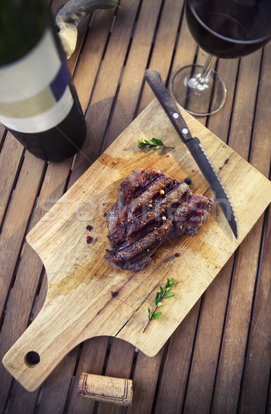 BBQ steak. Barbecue grilled beef steak meat with red wine and kn Stock photo © dashapetrenko