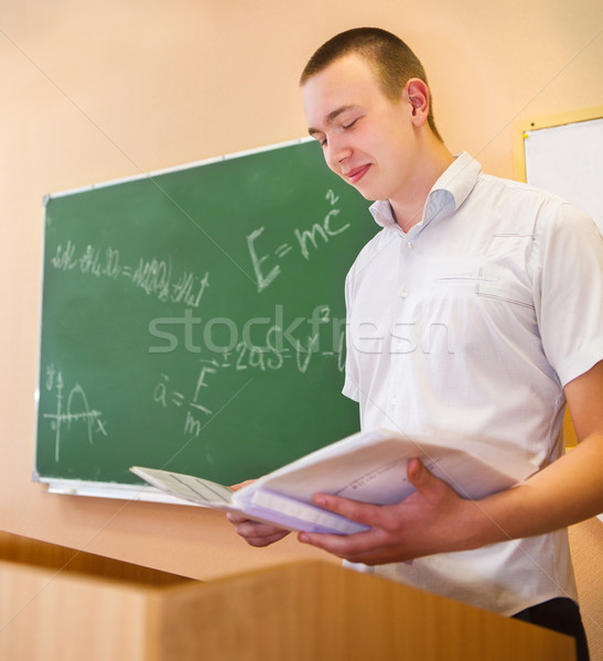 Student boy standing near the blackboard in the classroom Stock photo © dashapetrenko