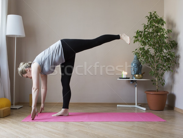Middle aged woman doing yoga indoors Stock photo © dashapetrenko