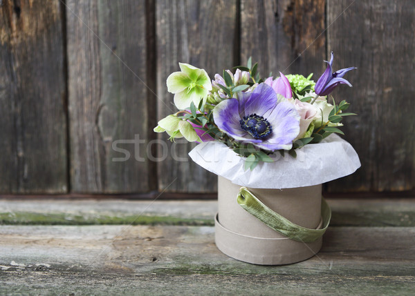 Bouquets of pink and violet flowers in the box on a woden backgr Stock photo © dashapetrenko
