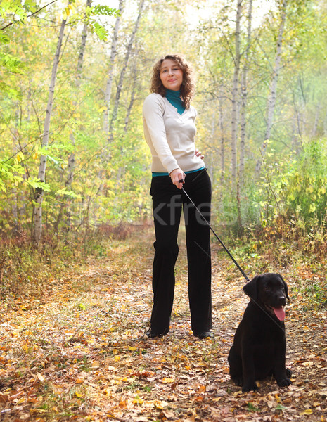 Young woman walking with black labrador retriever puppy  Stock photo © dashapetrenko