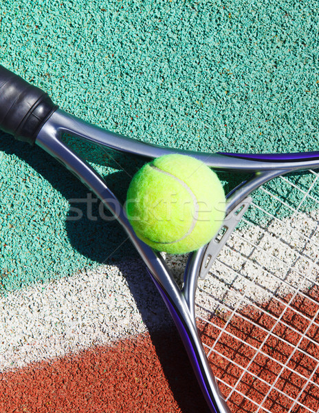 Close up of tennis racquet and ball on the tennis court Stock photo © dashapetrenko