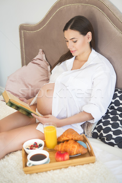 Pregnant woman having breakfast with coffee, orange juice, crois Stock photo © dashapetrenko