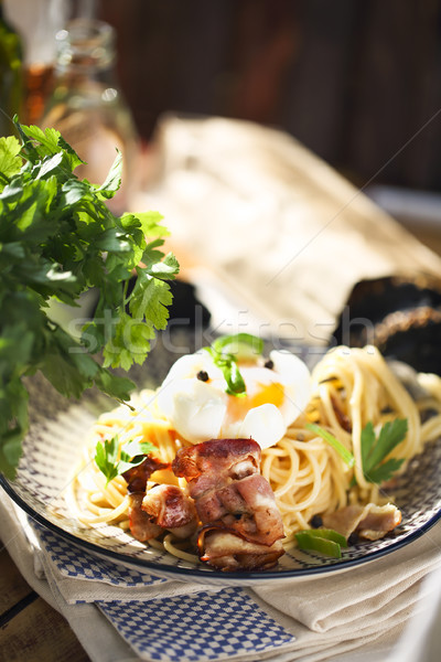 Nicely served spaghetti carbonara on black background  Stock photo © dashapetrenko