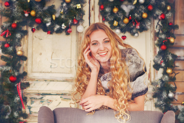 Beautiful happy woman in furcoat by the Christmas decorations Stock photo © dashapetrenko