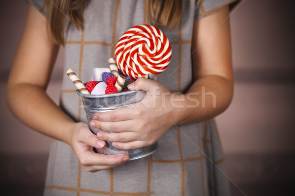 Bucket with colorful candies in the hands of little girl Stock photo © dashapetrenko