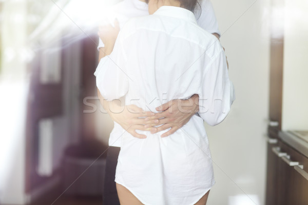 Young couple kisses and hugs at kitchen in the morning Stock photo © dashapetrenko