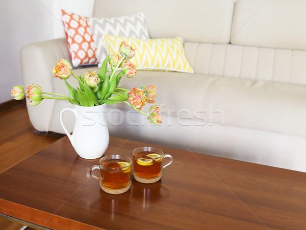 Beautiful orange tulips bouquet on wooden table in the living ro Stock photo © dashapetrenko