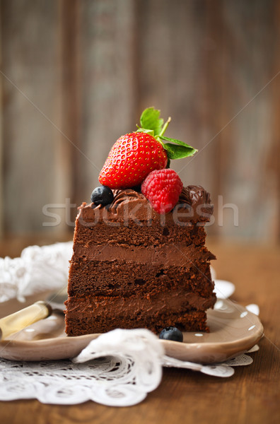 Piece of chocolate cake with icing and fresh berry  Stock photo © dashapetrenko