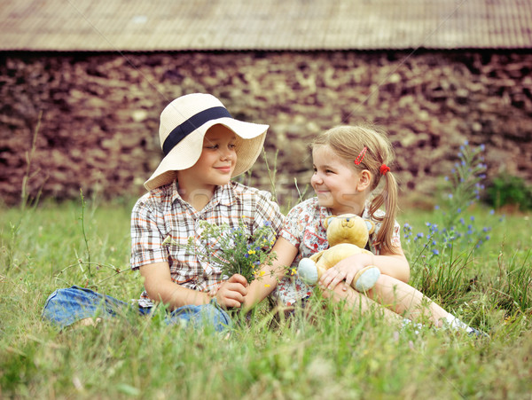 Little boy gives flowers to the little girl  Stock photo © dashapetrenko