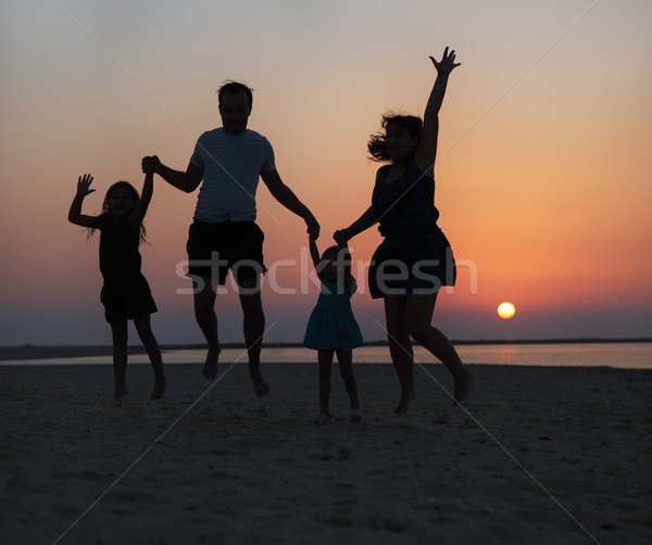 ストックフォト: 幸せ · 美しい · 家族 · ジャンプ · ビーチ · 日没