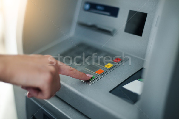 Woman using banking machine Stock photo © dashapetrenko