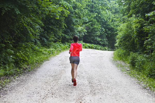 Young woman running on a countryside road Stock photo © dashapetrenko