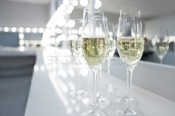 Champagne glasses on white background in bright lights Stock photo © dashapetrenko