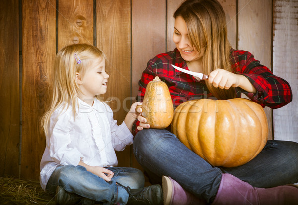Mother and daughter carving pumpkins Stock photo © dashapetrenko
