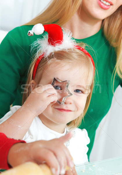 Adorable girls with her mother baking Christmas cookies in the k Stock photo © dashapetrenko