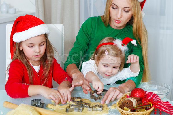 Two little girls with mother baking Christmas cookies Stock photo © dashapetrenko